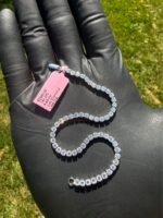 Solid 14K white gold tennis bracelet with 4.45 CTW lab-grown diamonds on a gloved hand with a pink tag