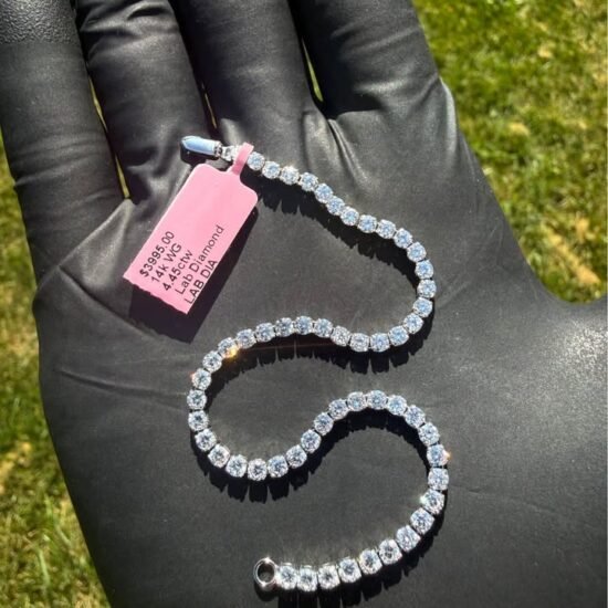 Solid 14K white gold tennis bracelet with 4.45 CTW lab-grown diamonds on a gloved hand with a pink tag