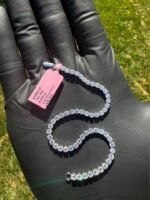 Solid 14K white gold tennis bracelet with 4.45 CTW lab-grown diamonds displayed on a gloved hand outdoors