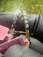 Solid 14K white gold tennis bracelet with 4.45 CTW lab-grown diamonds on a gloved hand with a pink tag, side view