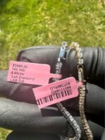 Solid 14K white gold tennis bracelet with 4.45 CTW lab-grown diamonds on a gloved hand with a pink tag, final view