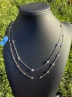 Solid 14K gold diamond by the yard necklace with 2.05-2.47 CTW lab-grown diamonds on a black bust, side view